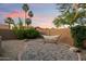 Charming backyard retreat with a hammock, desert landscaping and tall palm trees at 13361 N 99Th Pl, Scottsdale, AZ 85260