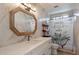 Elegant bathroom featuring marble tiled walls, a modern shower, and a stylish mirror and sink at 13361 N 99Th Pl, Scottsdale, AZ 85260