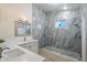Beautiful bathroom featuring a walk-in shower with marble tiling and a glass door at 13361 N 99Th Pl, Scottsdale, AZ 85260