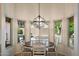 Bright dining area with backyard views and a stylish chandelier creates an inviting atmosphere at 13361 N 99Th Pl, Scottsdale, AZ 85260