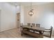 Bright dining room featuring a wood table and a modern chandelier above at 13361 N 99Th Pl, Scottsdale, AZ 85260