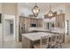 Modern kitchen with stainless steel appliances, a center island with seating, and decorative pendant lighting at 13361 N 99Th Pl, Scottsdale, AZ 85260