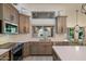 Well-equipped kitchen with stainless appliances, white countertops, and ample cabinet space overlooking the backyard at 13361 N 99Th Pl, Scottsdale, AZ 85260