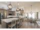 Bright, open kitchen and dining area with a large island, stainless steel appliances, and decorative lighting at 13361 N 99Th Pl, Scottsdale, AZ 85260