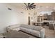 Open living space blending into a modern kitchen with stainless steel appliances and ample seating at 13361 N 99Th Pl, Scottsdale, AZ 85260
