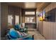 Relaxing covered patio featuring plush seating, TV, and pass-through window to the kitchen area at 13361 N 99Th Pl, Scottsdale, AZ 85260