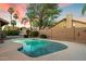 Sparkling pool surrounded by lush landscaping, brick perimeter wall, and picturesque sunset at 13361 N 99Th Pl, Scottsdale, AZ 85260