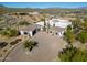 Desert home featuring mature palms, brick driveway, and covered garage at 13648 E Aloe Vera Dr, Scottsdale, AZ 85262