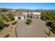 Desert home featuring mature palms, brick driveway, and covered garage at 13648 E Aloe Vera Dr, Scottsdale, AZ 85262