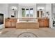 A luxurious bathroom with an oval tub, travertine floors, dual vanities, and a fireplace at 13648 E Aloe Vera Dr, Scottsdale, AZ 85262