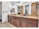 A well-lit bathroom with dual vanities and dark cabinets at 13648 E Aloe Vera Dr, Scottsdale, AZ 85262