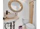 Bathroom features a round rattan mirror, stylish vessel sink, and a tiled shower at 13648 E Aloe Vera Dr, Scottsdale, AZ 85262