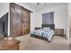 Bedroom features a modern bed with an unique sliding wood barn door at 13648 E Aloe Vera Dr, Scottsdale, AZ 85262