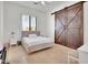 This bedroom is well lit with a soft, pink bed, and sliding barn doors at 13648 E Aloe Vera Dr, Scottsdale, AZ 85262