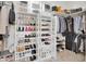 Walk-in closet with custom shelving for shoes, purses, and hanging storage at 13648 E Aloe Vera Dr, Scottsdale, AZ 85262