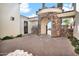 Charming stone archway entrance with detailed brickwork, leading to a private courtyard with manicured landscaping at 13648 E Aloe Vera Dr, Scottsdale, AZ 85262