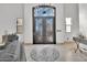 Grand foyer featuring a decorative tile inlay, ornate wrought iron double doors, and abundant natural light at 13648 E Aloe Vera Dr, Scottsdale, AZ 85262