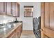 A laundry room with granite countertops, stainless steel sink, and modern washer and dryer at 13648 E Aloe Vera Dr, Scottsdale, AZ 85262