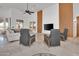 Bright, airy living room with travertine floors, a ceiling fan, modern TV console and comfortable seating arrangement at 13648 E Aloe Vera Dr, Scottsdale, AZ 85262