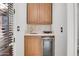Charming wet bar with wood cabinets, granite countertop, and a beverage cooler at 13648 E Aloe Vera Dr, Scottsdale, AZ 85262