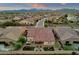 Aerial view of a residential community with houses featuring tile roofs, private backyards, and mountain views at 16105 N 183Rd Dr, Surprise, AZ 85388