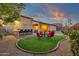 Outdoor kitchen and seating area perfect for entertaining guests in the backyard at 16105 N 183Rd Dr, Surprise, AZ 85388