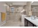 Modern bathroom featuring a glass-enclosed shower, tiled walls, and a sleek vanity at 16105 N 183Rd Dr, Surprise, AZ 85388