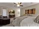 Spacious bedroom with a cozy fireplace, TV, and a view of the outdoor scenery at 16105 N 183Rd Dr, Surprise, AZ 85388