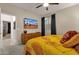 Comfortable bedroom showcasing a yellow comforter, a dresser, and a television on the wall at 16105 N 183Rd Dr, Surprise, AZ 85388
