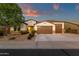 Charming single-story home with a well-manicured yard and a spacious three-car garage at 16105 N 183Rd Dr, Surprise, AZ 85388