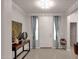 Bright foyer with neutral tile flooring, decorative lighting, and ample wall space for art at 16105 N 183Rd Dr, Surprise, AZ 85388