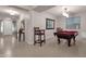 Game room with pool table, chairs, and ample natural light; perfect for entertaining at 16105 N 183Rd Dr, Surprise, AZ 85388
