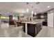 Open-concept kitchen with granite countertops, dark cabinetry, and stainless steel appliances at 16105 N 183Rd Dr, Surprise, AZ 85388