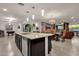 Spacious kitchen with central island, granite countertops, and open view of the dining area at 16105 N 183Rd Dr, Surprise, AZ 85388