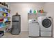 Bright laundry room featuring modern washer, dryer, and shelving for organized storage at 16105 N 183Rd Dr, Surprise, AZ 85388