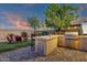 Outdoor kitchen area equipped with grill, bar, and backyard views at 16105 N 183Rd Dr, Surprise, AZ 85388