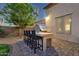 Outdoor bar area with built in grill and seating that complements backyard's design at 16105 N 183Rd Dr, Surprise, AZ 85388