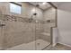 Walk-in shower featuring a glass enclosure, tiled walls, a rainfall showerhead, and a built-in seat at 16105 N 183Rd Dr, Surprise, AZ 85388