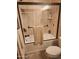 Tiled bathtub-shower combo with glass doors, matte fixtures, and convenient built-in shelves at 16805 S 29Th Pl, Phoenix, AZ 85048