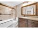 Well-lit bathroom showcases a combined bathtub-shower and vanity with traditional fixtures and lighting at 16805 S 29Th Pl, Phoenix, AZ 85048