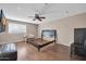 Large bedroom features ceiling fan, wood floors, and a large window at 16805 S 29Th Pl, Phoenix, AZ 85048