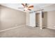 Bedroom with standard window, ceiling fan, plush carpeting, and a stylish barn door closet at 16805 S 29Th Pl, Phoenix, AZ 85048