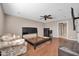 Spacious bedroom features ceiling fan, wood floors, and en suite bathroom at 16805 S 29Th Pl, Phoenix, AZ 85048