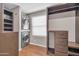 Walk-in closet with custom shelving and a stainless steel washer and dryer at 16805 S 29Th Pl, Phoenix, AZ 85048