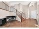 Grand foyer showcasing hardwood floors, elegant stairs, a piano, and bright lighting at 16805 S 29Th Pl, Phoenix, AZ 85048