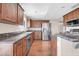 Beautiful kitchen featuring stainless steel appliances, granite countertops, dark wood cabinetry, and breakfast bar at 16805 S 29Th Pl, Phoenix, AZ 85048