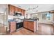 Modern kitchen featuring stainless steel appliances, granite countertops, dark wood cabinetry, and breakfast bar at 16805 S 29Th Pl, Phoenix, AZ 85048