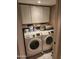 Laundry room with white washer and dryer and upper storage cabinets at 16805 S 29Th Pl, Phoenix, AZ 85048