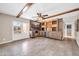 A spacious living room featuring a stylish wet bar, wooden beams and a seamless indoor-outdoor flow to the patio at 16805 S 29Th Pl, Phoenix, AZ 85048