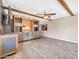 Entertainer's dream: Open living area features bar with beverage coolers and stone wall with display shelving at 16805 S 29Th Pl, Phoenix, AZ 85048